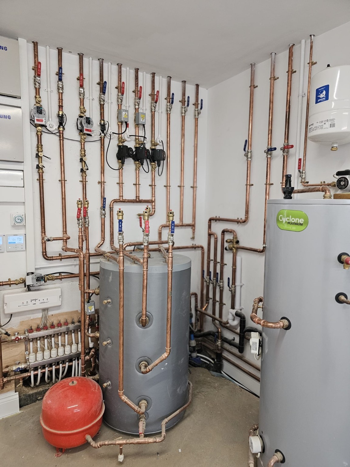 Heating system installation with copper pipework and hot water cylinder