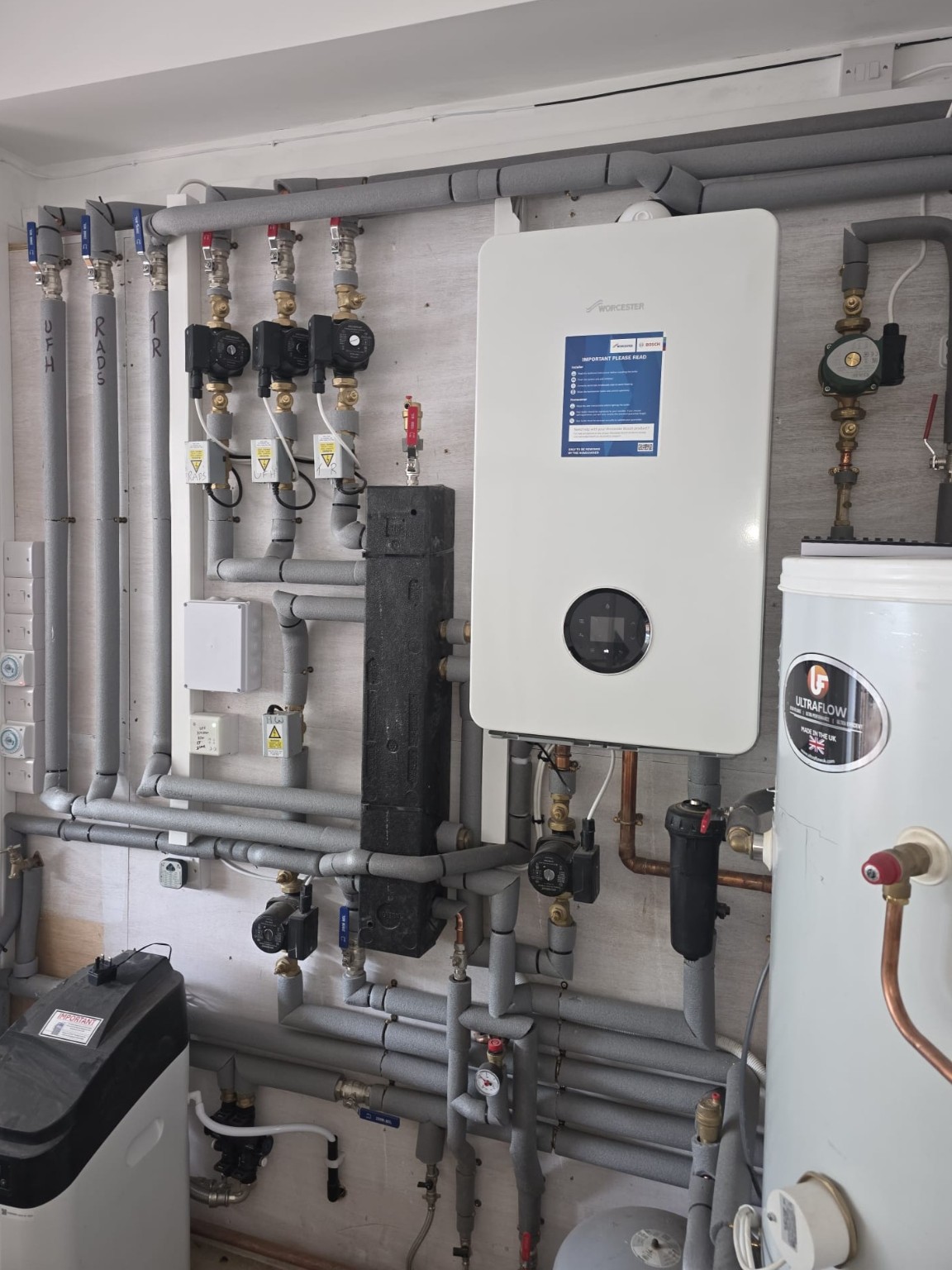 Boiler and heating system installation with pipework and controls